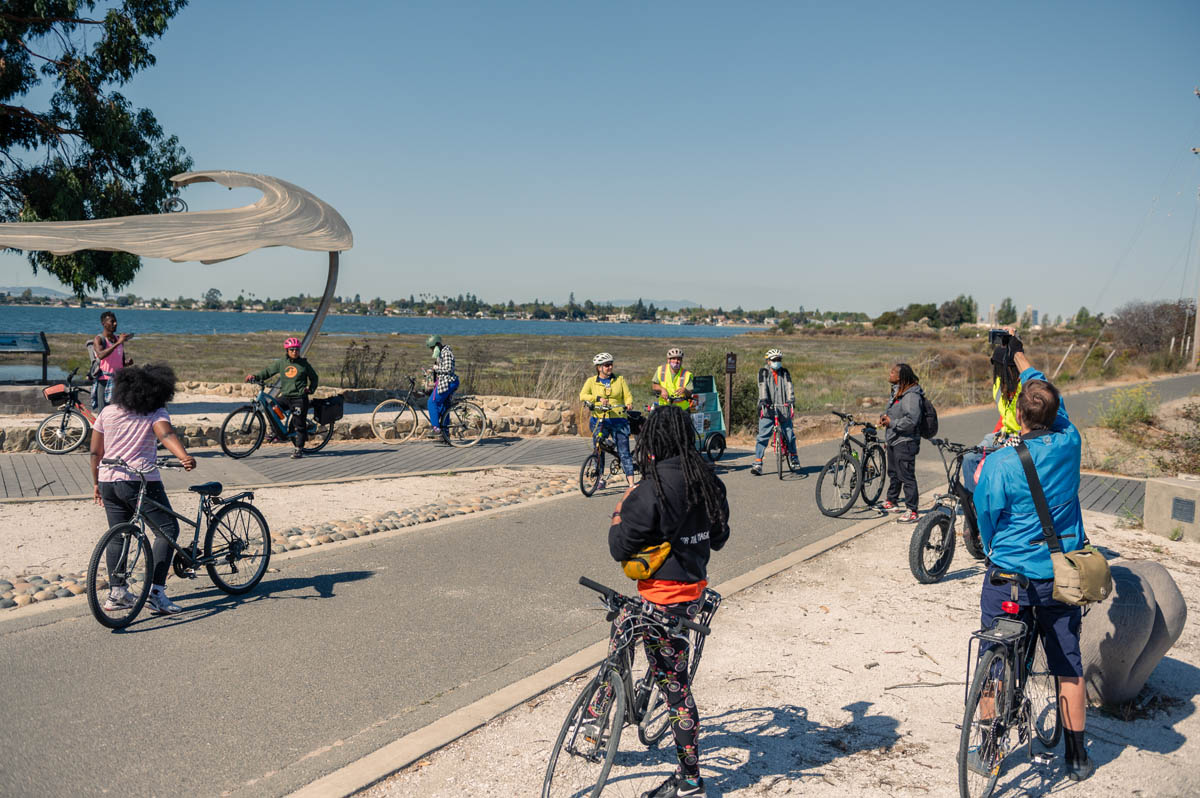 cyclists arrive at the shore sculpture