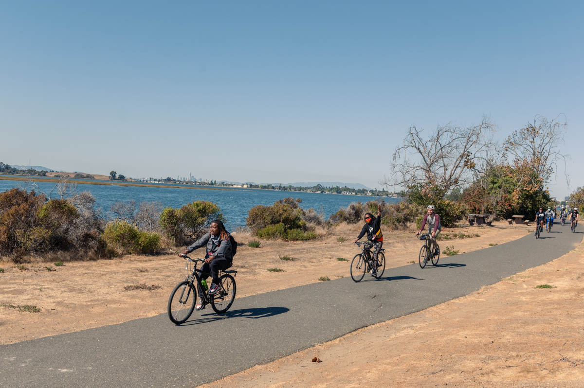 cyclists going along the waterfront trail, Keta i the lead