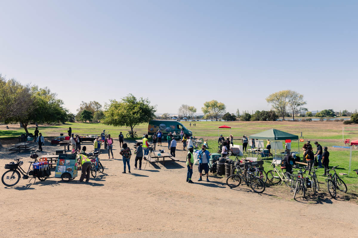 overview of picnic party with tens and vans and trees and bikes