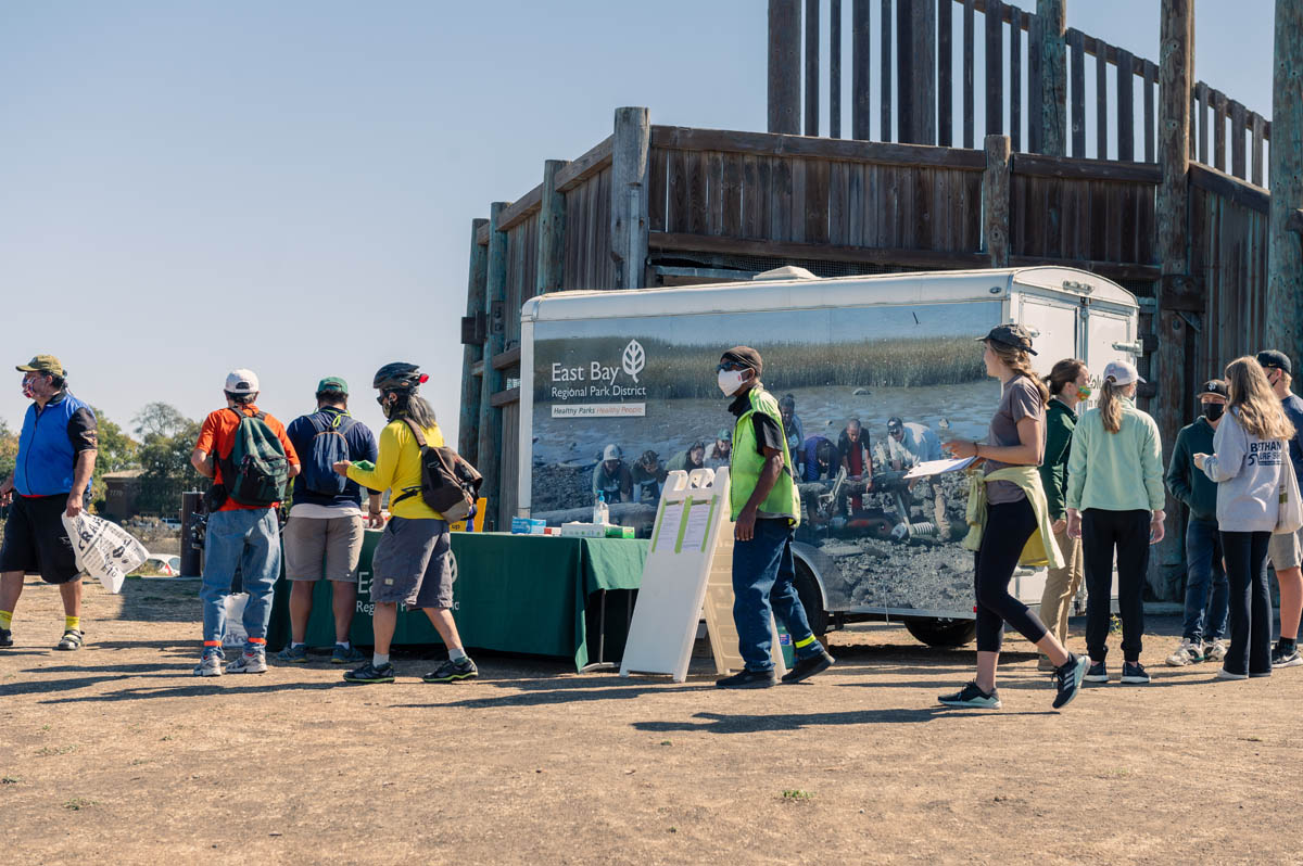 group stands at shore getting ready for clean up