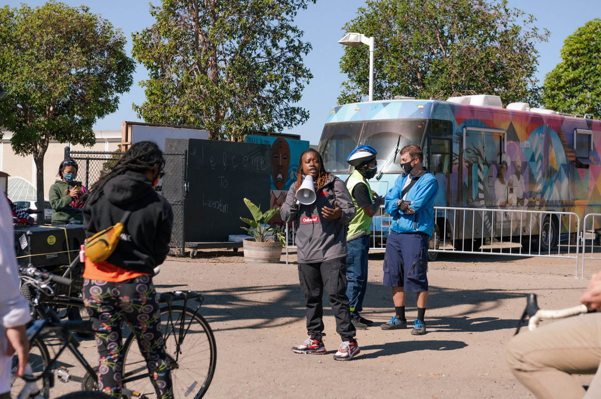 Keta price with megaphone welcomes riders to the event