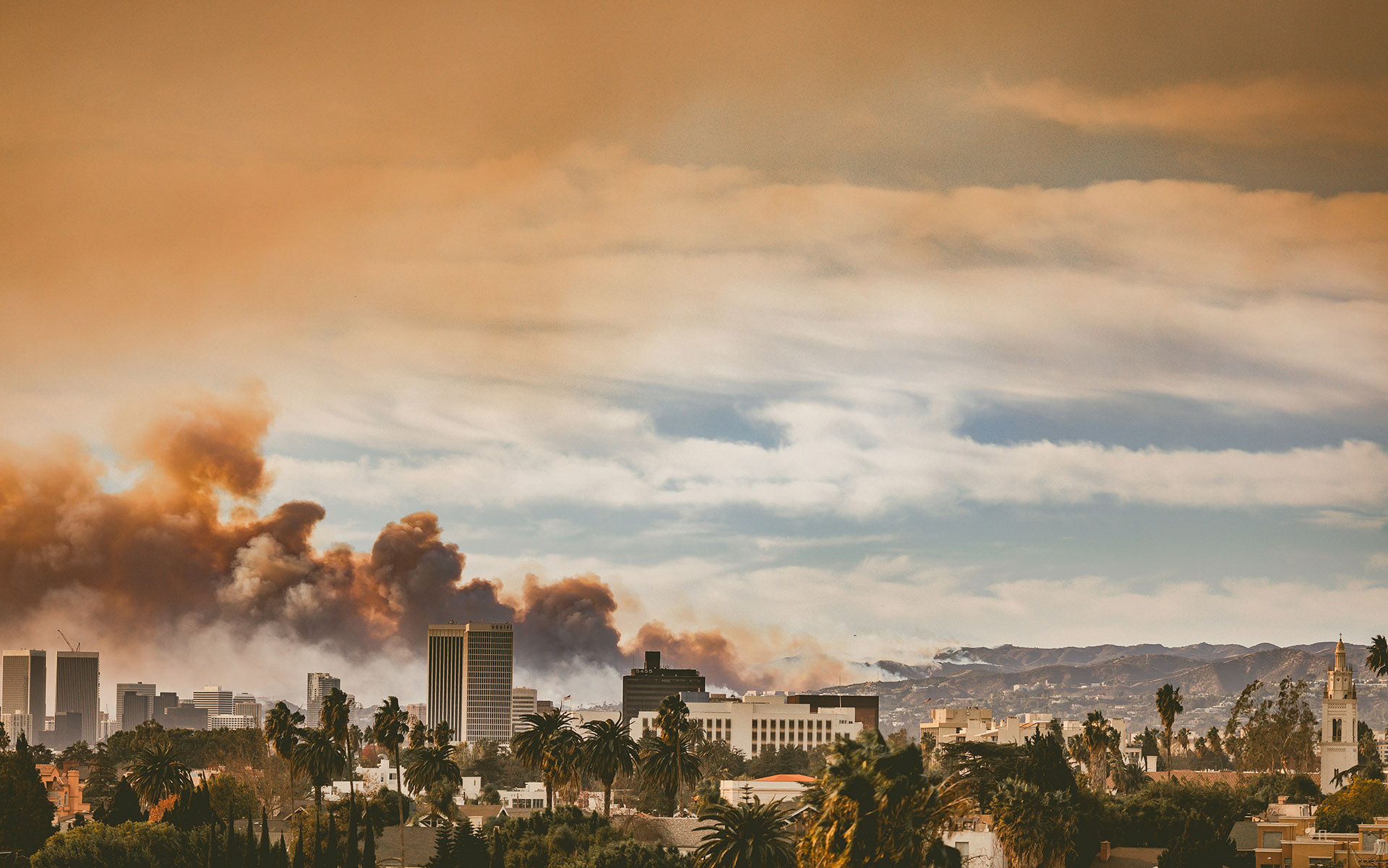 January 2025 Onset of the Eaton Fire in Los Angeles, only one of thousands of images burning on our screens and reminding us that the California dream of the past — beaches, palm trees, development patterns dictated by cars, and water piped and pumped from far away — remains fraught with risk in the future. Beyond our empathy and shared lived experience with our Los Angeles neighbors, KneeDeep hopes the conversation ahead includes more attention to radical change in land use planning, including incentives to move away from zones of risk. Photo by Jessica Christian on Unsplash.