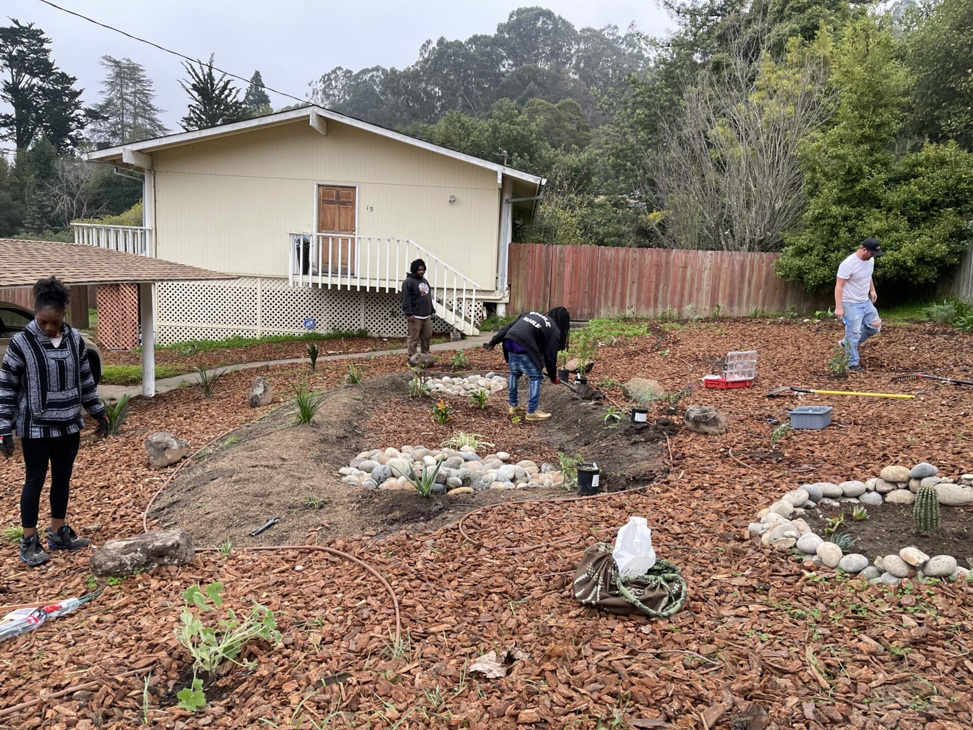 Community stewards install the first garden of many to come, a mix of native and African-heritage drought resistant plants. Photo: June Farmer.