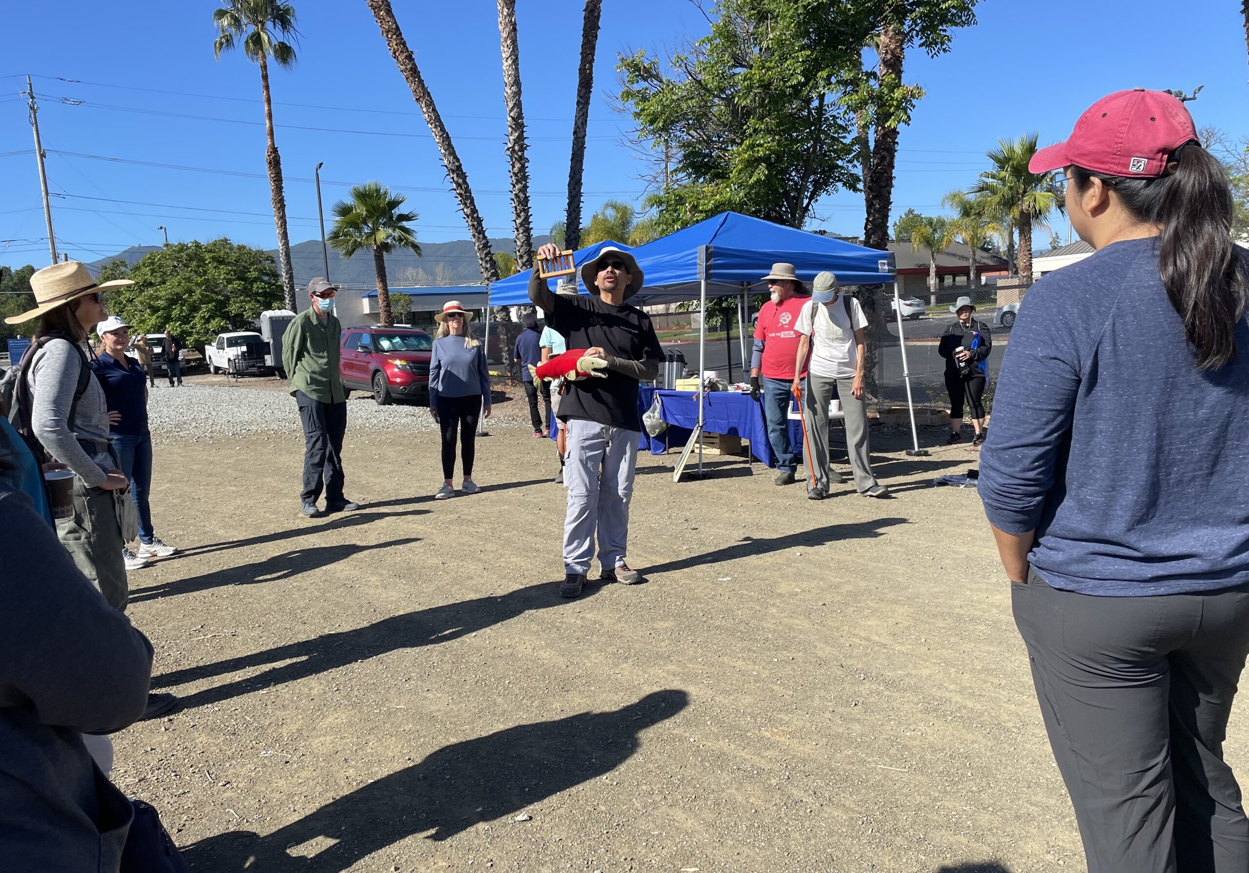 Volunteers get tips on trash removal techniques.