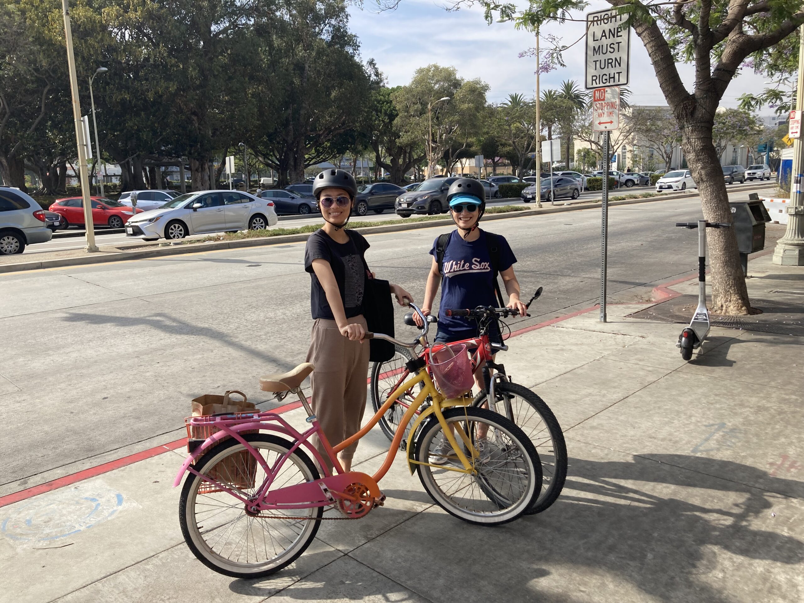 Friends standing beside their bikes.