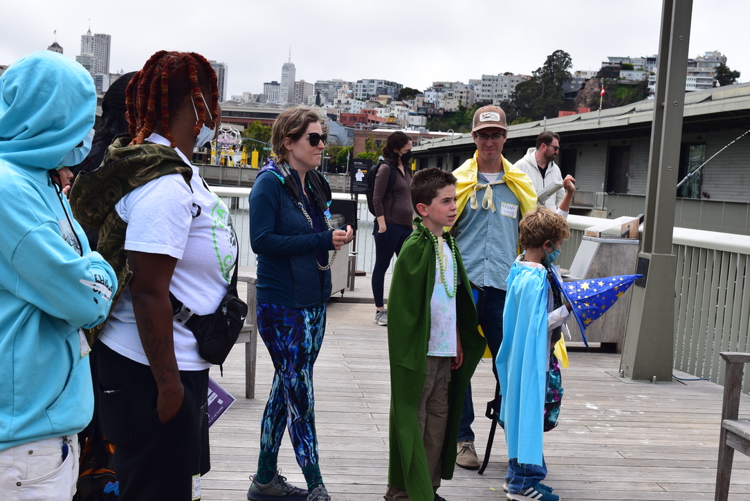 Players speak with a volunteer about taking down the potion plant. Photo: Aiyana Washington.