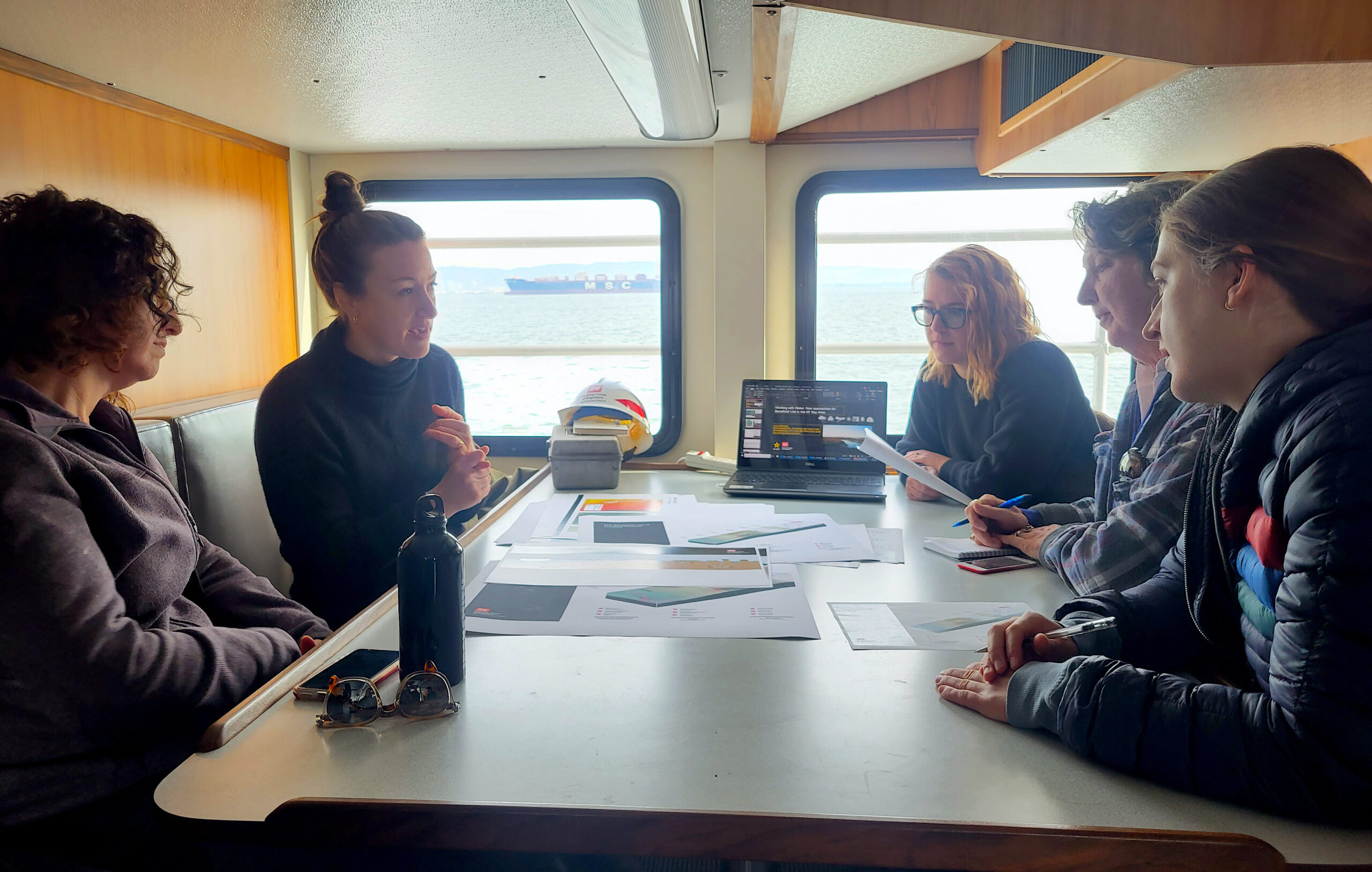 Corps’ Julie Beagle explains project to reporters below deck.