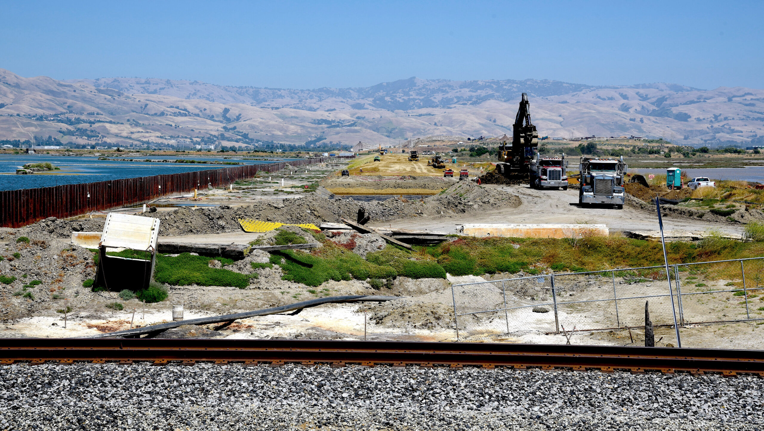 The region’s largest multi-jurisdiction levee project in recent history near San Jose in July 2024. The project is being built reach by reach (excavation for Reach 2/3 is nearing completion and most of Reach 1 is at levee target elevation above 15.2 feet). The photo looks east and pond A12 is in the foreground.