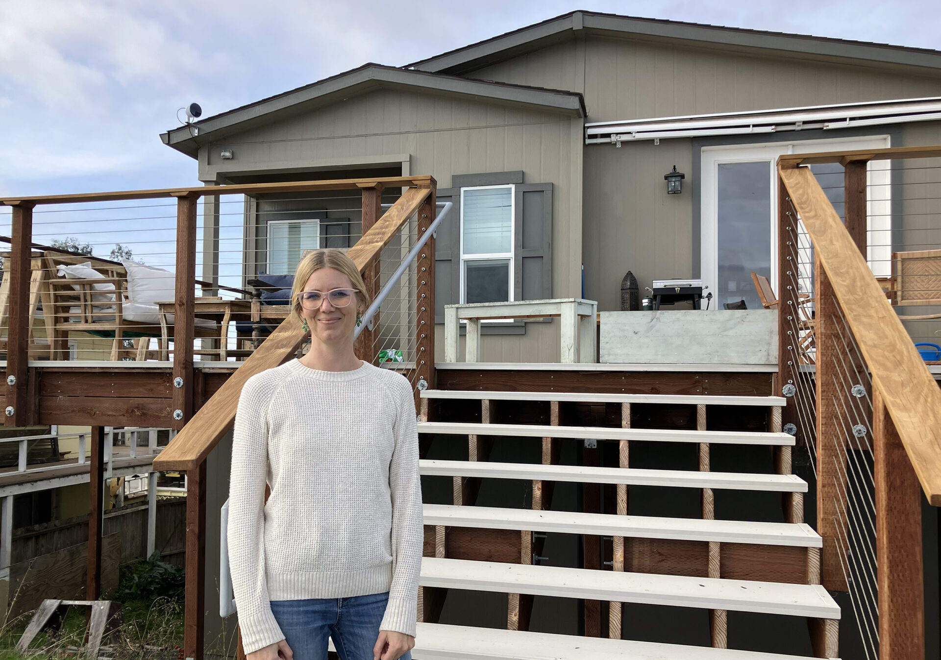 Erica Neubauer in front of her raised house. Photo: Mary Catherine O’Connor